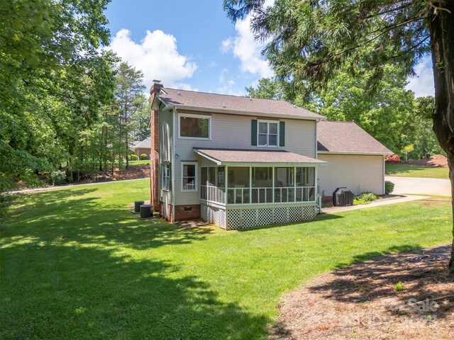 312 Briarwood Dr, Rutherfordton, NC 28139 - rear view of house featuring a chimney, a sunroom, a lawn, cooling unit, and a shingled roof