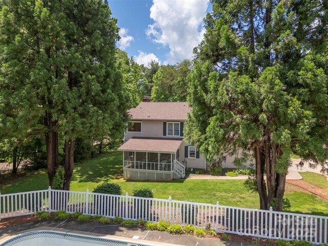 312 Briarwood Dr, Rutherfordton, NC 28139 - back of property featuring a sunroom, a chimney, and roof with shingles