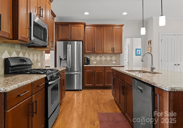 2606 Walker Rd, Matthews, NC 28105 - kitchen with stainless steel appliances, a sink, crown molding, light wood-type flooring, and decorative backsplash