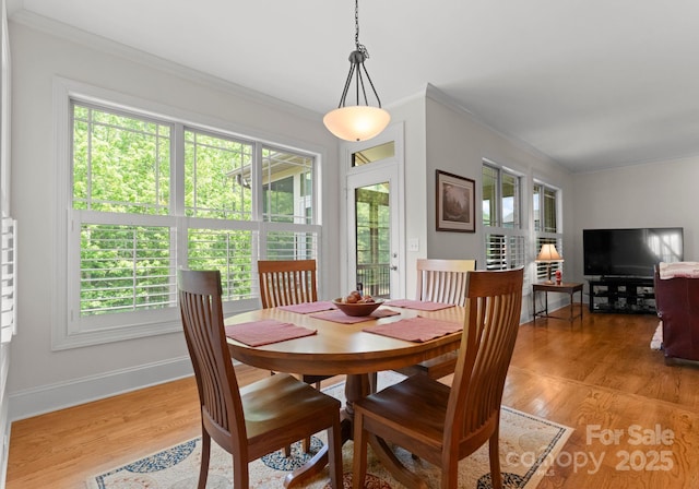2606 Walker Rd, Matthews, NC 28105 - dining area with crown molding, light wood-type flooring, and baseboards