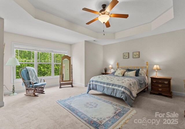 2606 Walker Rd, Matthews, NC 28105 - carpeted bedroom featuring baseboards, a tray ceiling, and ceiling fan