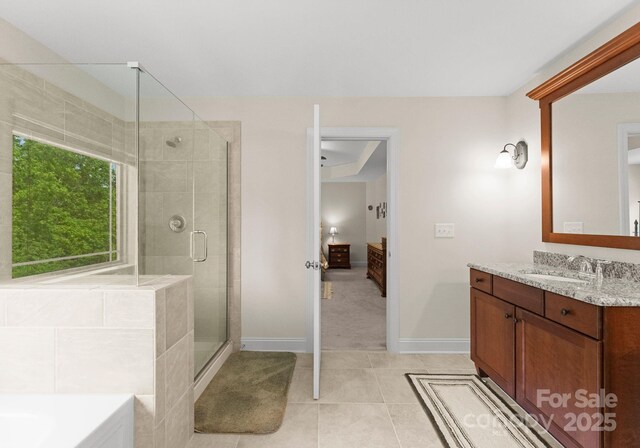 2606 Walker Rd, Matthews, NC 28105 - bathroom featuring a stall shower, tile patterned flooring, baseboards, vanity, and ensuite bathroom