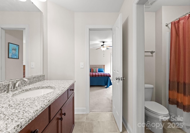 2606 Walker Rd, Matthews, NC 28105 - bathroom with toilet, a ceiling fan, vanity, baseboards, and ensuite bathroom