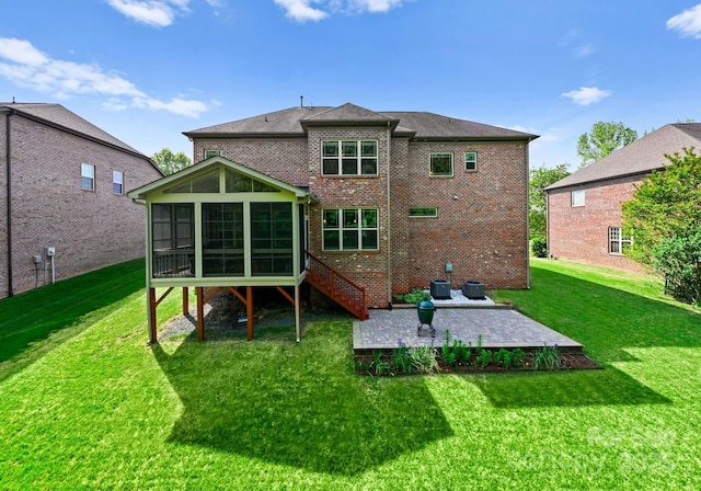 2606 Walker Rd, Matthews, NC 28105 - back of property featuring a patio area, a sunroom, a lawn, and brick siding