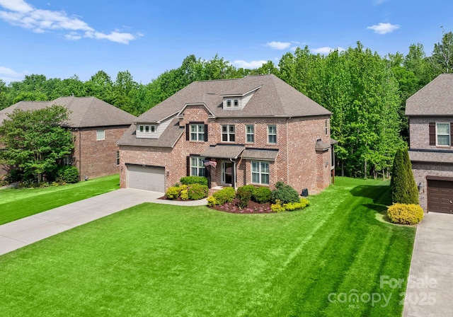 2606 Walker Rd, Matthews, NC 28105 - view of front of property featuring brick siding, concrete driveway, a front yard, and a garage