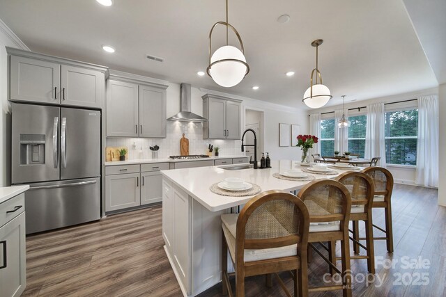 13222 Fiore Pl, Huntersville, NC 28078 - kitchen featuring appliances with stainless steel finishes, a sink, gray cabinetry, wall chimney exhaust hood, and light countertops
