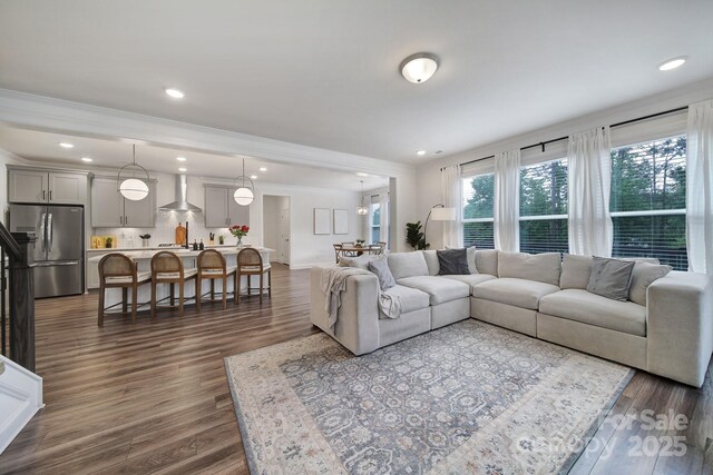 13222 Fiore Pl, Huntersville, NC 28078 - living room featuring dark wood-type flooring, crown molding, and recessed lighting
