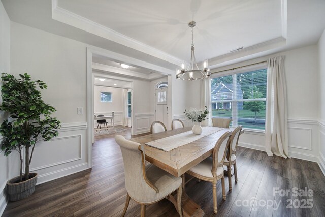 13222 Fiore Pl, Huntersville, NC 28078 - dining area with a decorative wall, a tray ceiling, a chandelier, wainscoting, and crown molding
