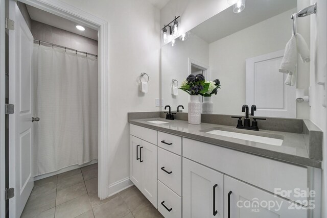 13222 Fiore Pl, Huntersville, NC 28078 - full bathroom featuring tile patterned floors, double vanity, and baseboards