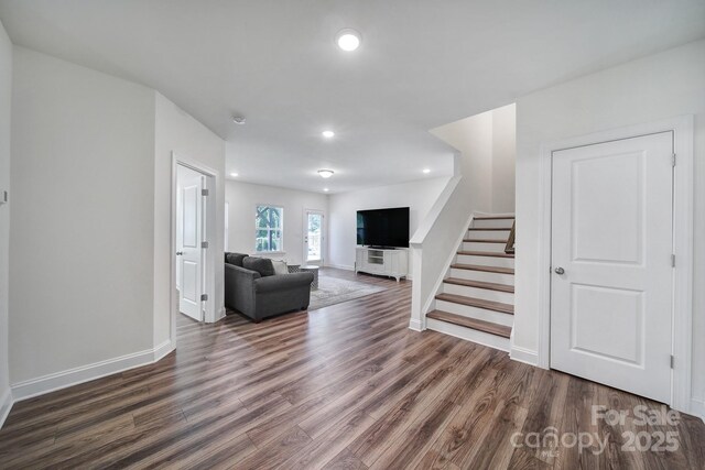 13222 Fiore Pl, Huntersville, NC 28078 - living area featuring wood finished floors, stairway, baseboards, and recessed lighting