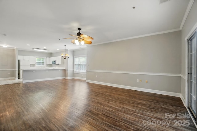 8731 Coralbell Ln, Charlotte, NC 28213 - unfurnished living room featuring ceiling fan, a chandelier, wood finished floors, baseboards, and ornamental molding