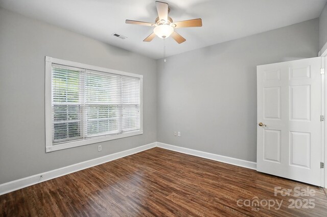 8731 Coralbell Ln, Charlotte, NC 28213 - unfurnished room with ceiling fan, baseboards, and dark wood-style floors