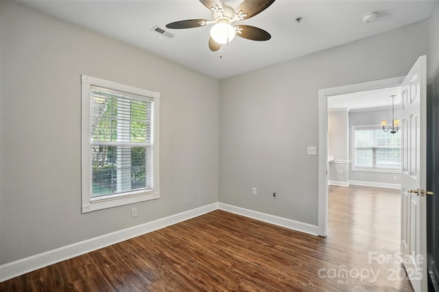 8731 Coralbell Ln, Charlotte, NC 28213 - unfurnished room with healthy amount of natural light, wood finished floors, a chandelier, and baseboards