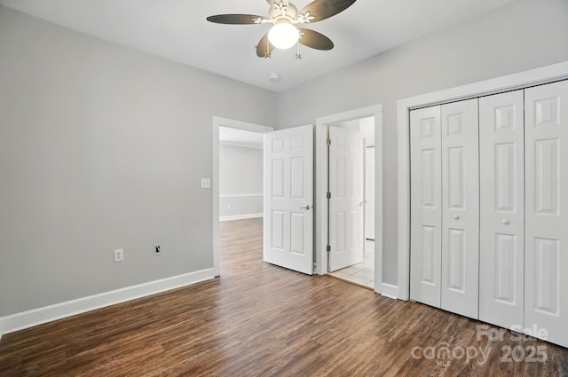 8731 Coralbell Ln, Charlotte, NC 28213 - unfurnished bedroom with wood finished floors, baseboards, a closet, and ceiling fan