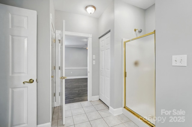 8731 Coralbell Ln, Charlotte, NC 28213 - bathroom with a stall shower, tile patterned floors, baseboards, and a ceiling fan