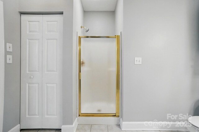 8731 Coralbell Ln, Charlotte, NC 28213 - full bathroom with a shower stall, a closet, baseboards, and tile patterned floors