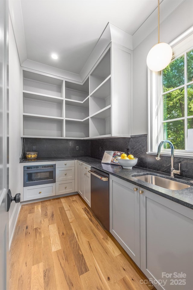 kitchen featuring open shelves, a sink, stainless steel dishwasher, oven, and backsplash