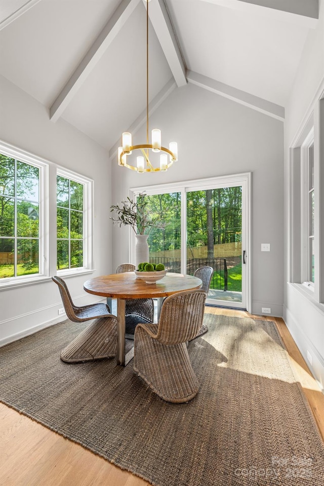 dining space featuring a chandelier, wood finished floors, and baseboards