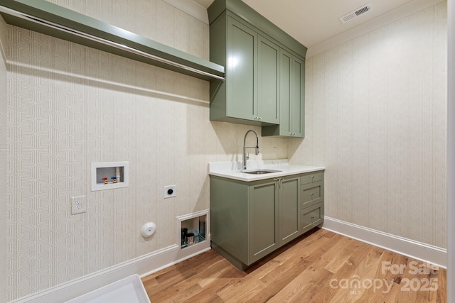 laundry area featuring hookup for a gas dryer, light wood finished floors, hookup for an electric dryer, hookup for a washing machine, and wallpapered walls
