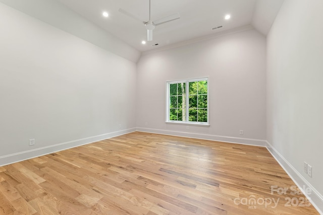 empty room with ceiling fan, light wood finished floors, baseboards, recessed lighting, and lofted ceiling