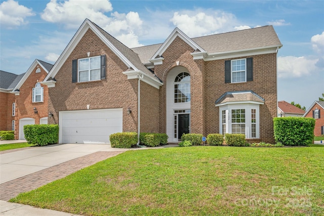 14104 Kendrick Cross Rd, Charlotte, NC 28273 - view of front of house featuring a garage, concrete driveway, brick siding, a front yard, and roof with shingles