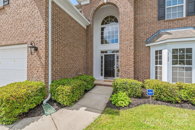 14104 Kendrick Cross Rd, Charlotte, NC 28273 - property entrance featuring an attached garage and brick siding