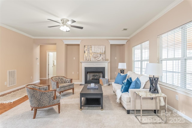 14104 Kendrick Cross Rd, Charlotte, NC 28273 - living room featuring ornamental molding, a fireplace with flush hearth, a ceiling fan, and baseboards