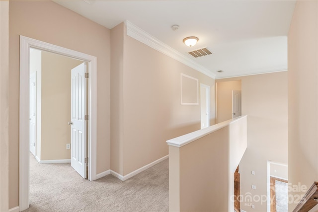 14104 Kendrick Cross Rd, Charlotte, NC 28273 - hallway with an upstairs landing, light carpet, crown molding, and baseboards