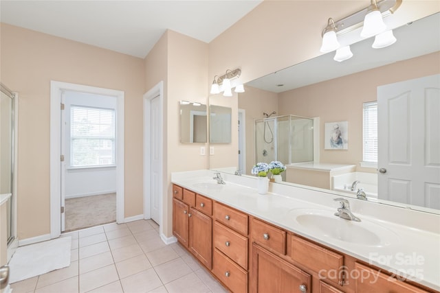 14104 Kendrick Cross Rd, Charlotte, NC 28273 - bathroom with a stall shower, double vanity, a garden tub, baseboards, and tile patterned floors