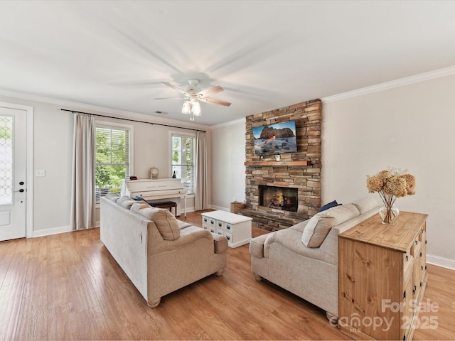 3801 Creek Ridge Dr, Denver, NC 28037 - living area with ornamental molding, light wood-style flooring, a stone fireplace, baseboards, and a ceiling fan