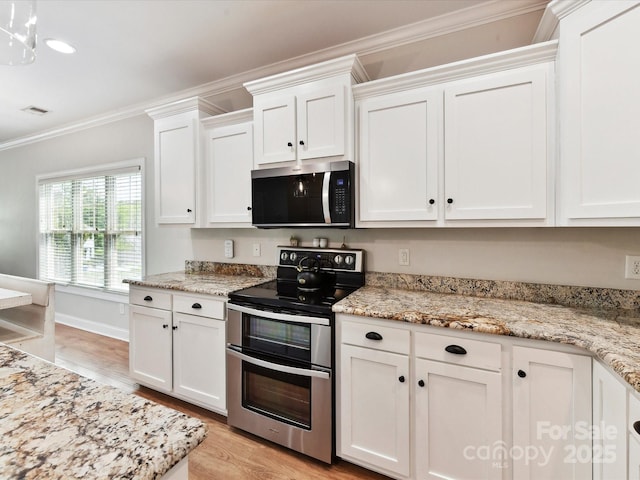 3801 Creek Ridge Dr, Denver, NC 28037 - kitchen with appliances with stainless steel finishes, white cabinetry, ornamental molding, light wood-style flooring, and light stone countertops