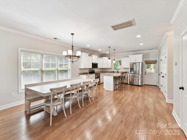 3801 Creek Ridge Dr, Denver, NC 28037 - dining area with healthy amount of natural light, light wood-style flooring, crown molding, recessed lighting, and baseboards