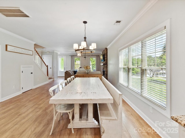 3801 Creek Ridge Dr, Denver, NC 28037 - dining room featuring crown molding, stairs, a chandelier, light wood-style floors, and baseboards