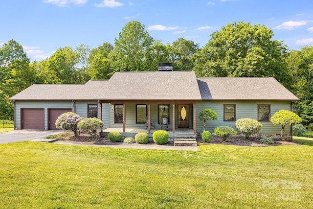 view of front of house featuring a porch, driveway, a chimney, an attached garage, and a front yard
