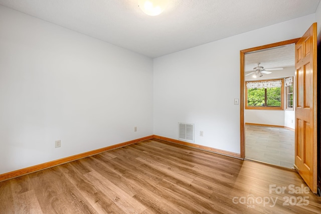unfurnished room with light wood-style flooring, baseboards, and ceiling fan