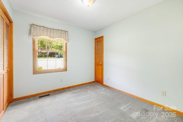 unfurnished bedroom featuring carpet flooring, a closet, and baseboards