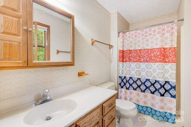 bathroom with toilet, vanity, a textured ceiling, curtained shower, and wallpapered walls