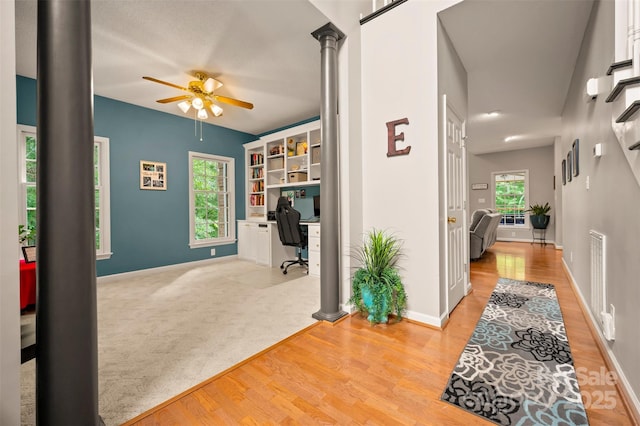 144 Chickasaw Dr, Shelby, NC 28152 - home office with a ceiling fan, ornate columns, light wood-style flooring, and baseboards