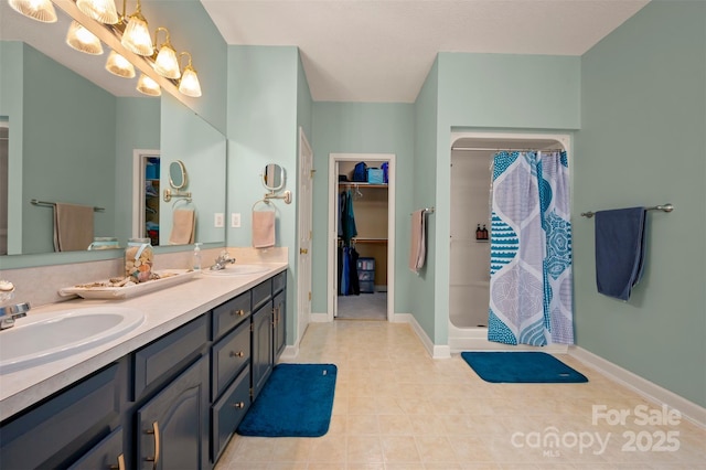 144 Chickasaw Dr, Shelby, NC 28152 - full bathroom with double vanity, a shower stall, tile patterned floors, and baseboards