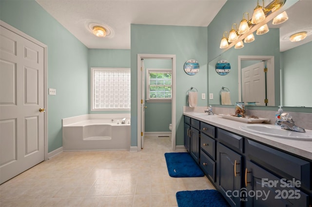 144 Chickasaw Dr, Shelby, NC 28152 - bathroom with double vanity, a bath, toilet, baseboards, and tile patterned flooring