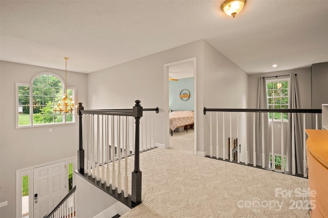 144 Chickasaw Dr, Shelby, NC 28152 - corridor featuring an upstairs landing, carpet flooring, a chandelier, and baseboards