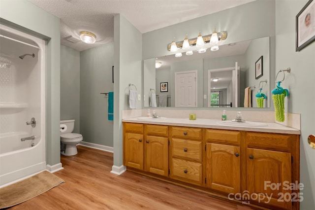 144 Chickasaw Dr, Shelby, NC 28152 - bathroom with toilet, double vanity, wood finished floors,  shower combination, and baseboards
