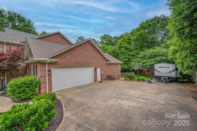 144 Chickasaw Dr, Shelby, NC 28152 - view of side of home with brick siding, a shingled roof, a garage, and driveway