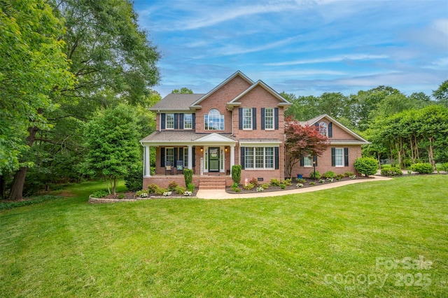 144 Chickasaw Dr, Shelby, NC 28152 - colonial-style house featuring a porch, brick siding, and a front yard