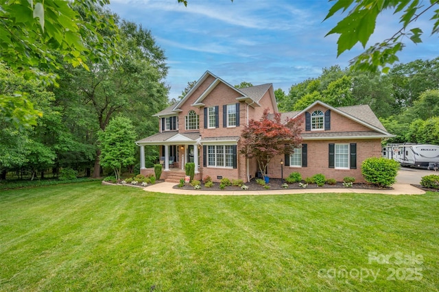 144 Chickasaw Dr, Shelby, NC 28152 - colonial-style house featuring brick siding and a front lawn
