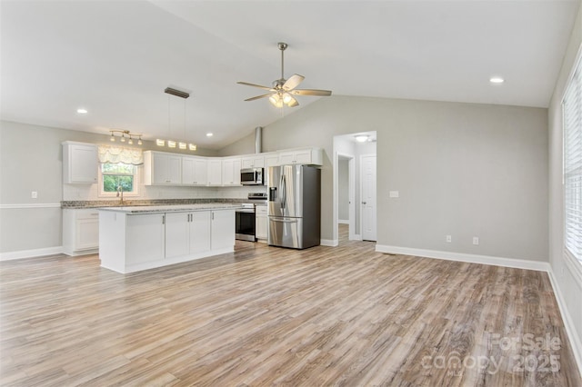 154 Stable Brook Ln, Taylorsville, NC 28681 - kitchen with appliances with stainless steel finishes, light wood-style floors, white cabinetry, vaulted ceiling, and recessed lighting