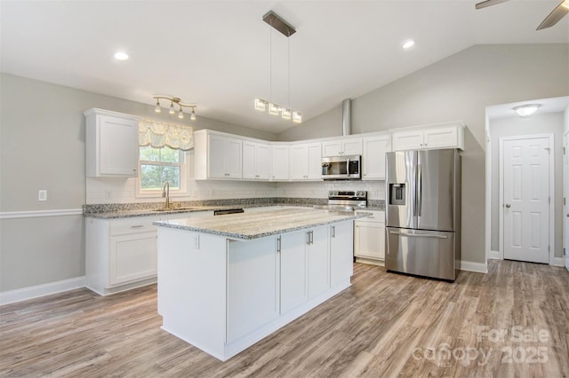 154 Stable Brook Ln, Taylorsville, NC 28681 - kitchen featuring stainless steel appliances, a sink, white cabinetry, backsplash, and lofted ceiling
