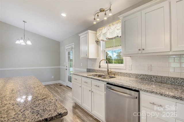 154 Stable Brook Ln, Taylorsville, NC 28681 - kitchen featuring dishwasher, a sink, lofted ceiling, tasteful backsplash, and light wood-style flooring
