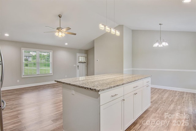 154 Stable Brook Ln, Taylorsville, NC 28681 - kitchen featuring open floor plan, light wood-style floors, a ceiling fan, lofted ceiling, and a center island