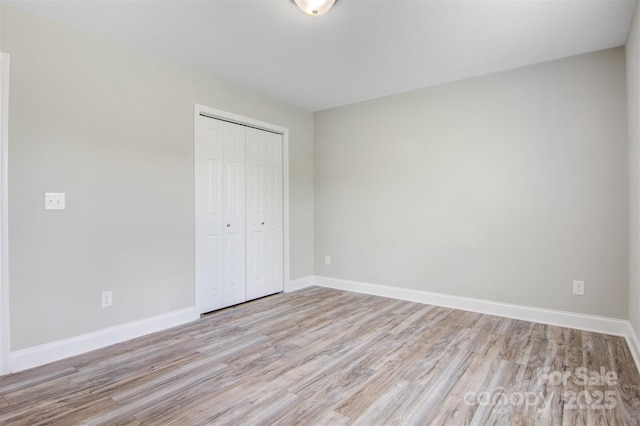 154 Stable Brook Ln, Taylorsville, NC 28681 - unfurnished bedroom featuring wood finished floors, a closet, and baseboards